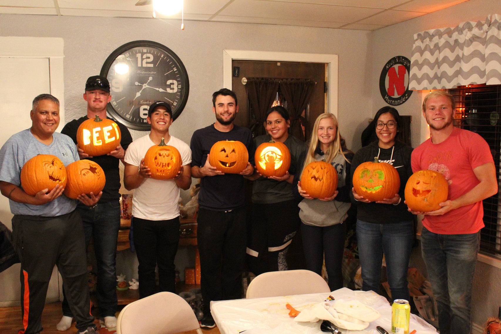 The Hernandez have their dorm kids over for pumpkin carving