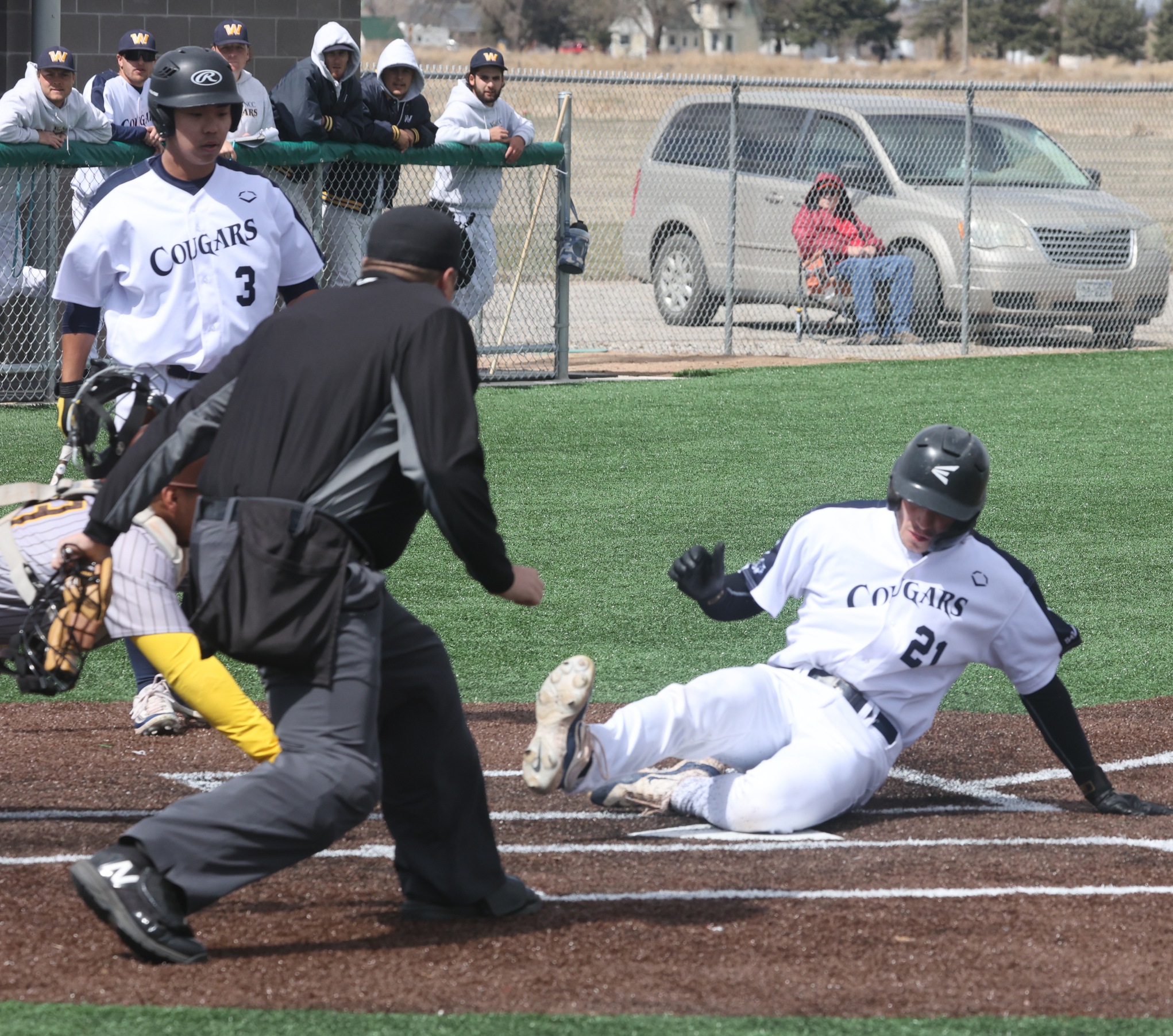 Caleb Caciari slides into home plate for the first run of the game on Tuesday against Garden City.