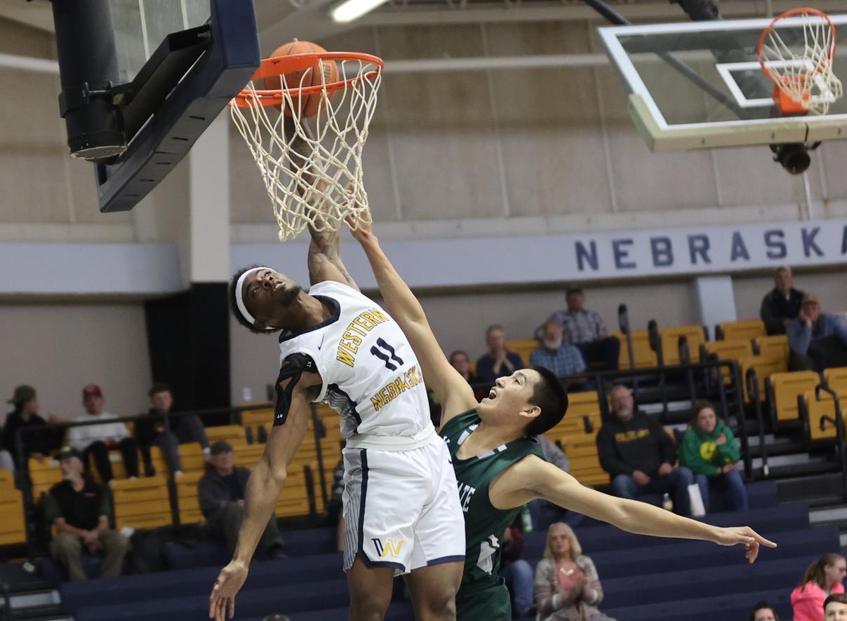 WNCC's Camryn Dennis goes for a slam during their game with Adam State JV.