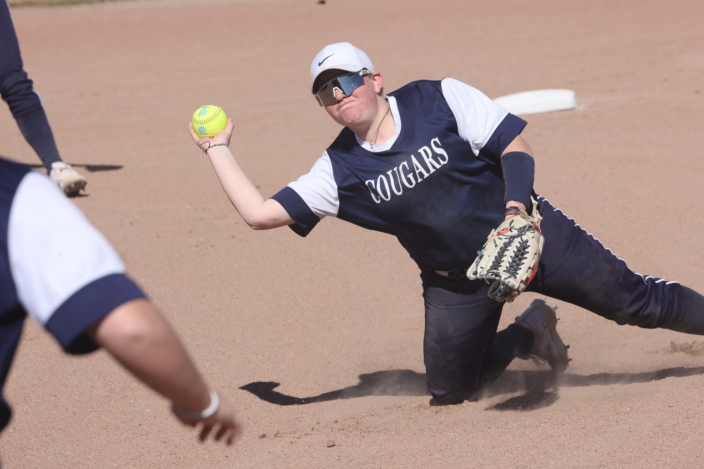 Sierra Hilgner throws to first base from her second base position for an out.