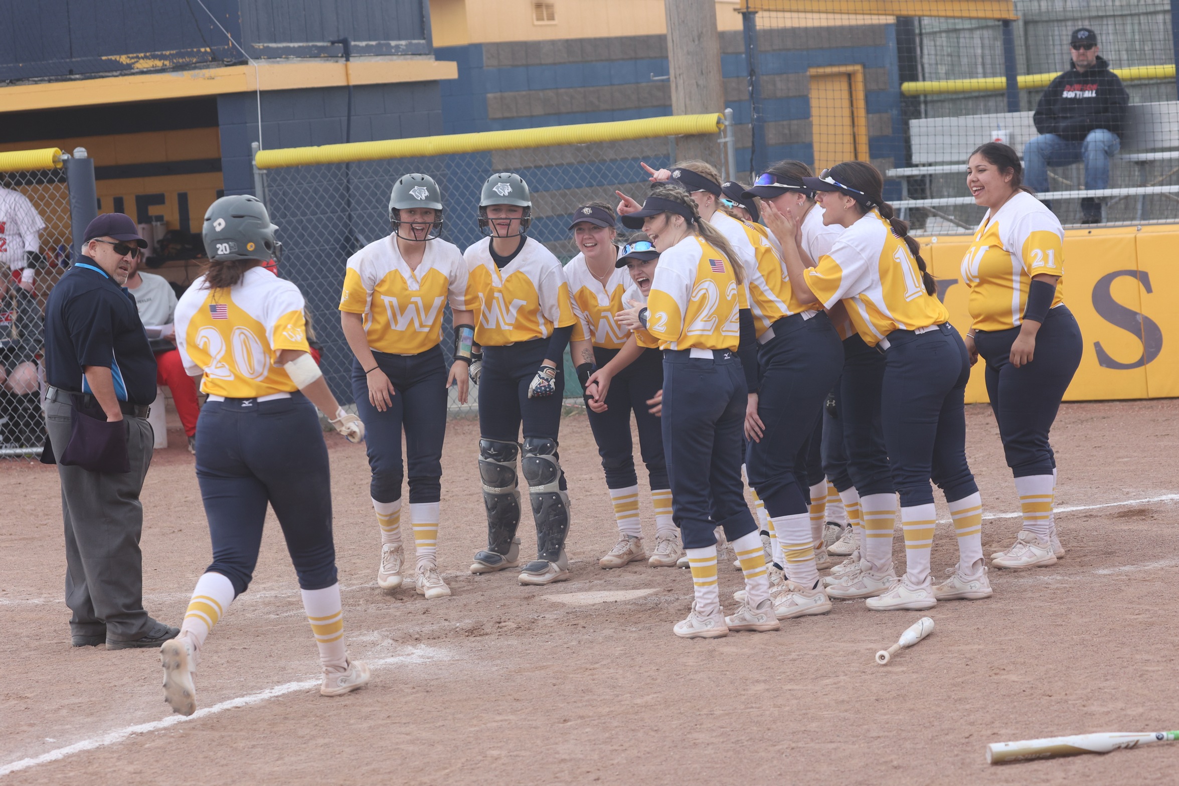 Jenika Fuentes gets celebrated at home plate after her 2-run home run.