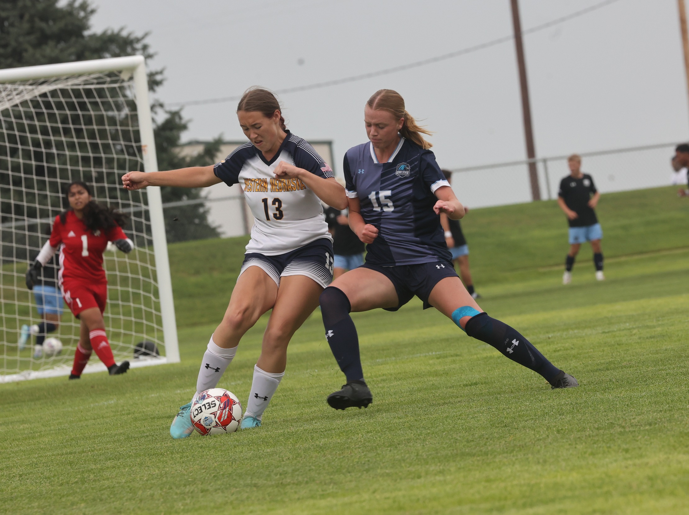 Audrey Gosvener battles a Utah State-Eastern player fo the ball.