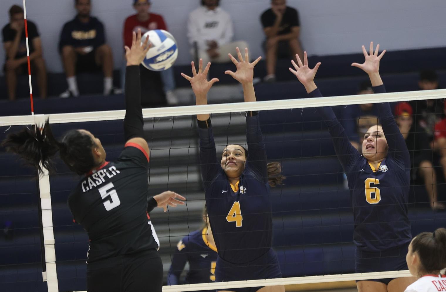 Shanelle Martinez and Alex Hernandez go up for a block.